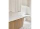 Close-up view of laundry room featuring white cabinets, desk area, and tile floors at 1123 Fern Hill Rd, Mooresville, NC 28117