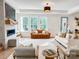 Bright living room with modern fireplace, multiple seating options and natural light at 1123 Fern Hill Rd, Mooresville, NC 28117