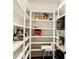 Well-organized walk-in pantry with ample shelving for storage and a microwave at 1123 Fern Hill Rd, Mooresville, NC 28117