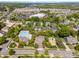 Aerial view highlights a neighborhood with community pool, playground, and manicured green spaces near shops at 1151 Donelea Nw Ln, Concord, NC 28027