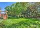 Expansive backyard with lush green grass and mature trees, offering plenty of space for outdoor activities at 1151 Donelea Nw Ln, Concord, NC 28027
