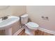 Bright bathroom featuring a modern pedestal sink and toilet with a clean, neutral color scheme at 1151 Donelea Nw Ln, Concord, NC 28027