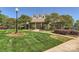Charming clubhouse with stone accents, mature trees, and manicured lawn in a well-maintained community at 1151 Donelea Nw Ln, Concord, NC 28027
