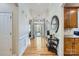 Elegant foyer with gleaming hardwood floors, wainscoting, and arched entryways to the living spaces at 1151 Donelea Nw Ln, Concord, NC 28027