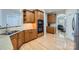 Well-lit kitchen features light-colored wood floors, wooden cabinets and granite countertops at 1151 Donelea Nw Ln, Concord, NC 28027