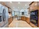 Open kitchen features stainless appliances, wood cabinets and light-colored hardwood floors at 1151 Donelea Nw Ln, Concord, NC 28027