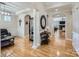 Open-concept living room with hardwood floors, crown molding, and elegant arched doorways at 1151 Donelea Nw Ln, Concord, NC 28027