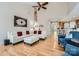 Open floor plan with hardwood floors, white furniture, and kitchen/dining area in background at 1151 Donelea Nw Ln, Concord, NC 28027
