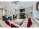 Living room with hardwood floors, white sectional couch with red pillows and a stone fireplace at 1151 Donelea Nw Ln, Concord, NC 28027