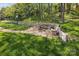 Spacious backyard with a built-in fire pit area and wooden retaining walls at 117 Tom Sawyer Ln, Mount Holly, NC 28120