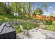 Large backyard featuring a fire pit area, basketball hoop, and outdoor seating at 117 Tom Sawyer Ln, Mount Holly, NC 28120