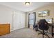 Bedroom featuring double door closet, TV, and desk at 117 Tom Sawyer Ln, Mount Holly, NC 28120