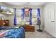 Stylized bedroom featuring TV, blue drapes, and closet at 117 Tom Sawyer Ln, Mount Holly, NC 28120