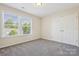 Bright bedroom featuring a large window and double door closet at 117 Tom Sawyer Ln, Mount Holly, NC 28120