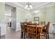 Well-lit dining room featuring a wooden table set and decorative light fixture at 117 Tom Sawyer Ln, Mount Holly, NC 28120