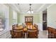 Dining room with hardwood table, chairs, decorative hutch, and plenty of natural light at 117 Tom Sawyer Ln, Mount Holly, NC 28120