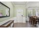 Inviting foyer featuring gray flooring, a white front door, and light green walls at 117 Tom Sawyer Ln, Mount Holly, NC 28120