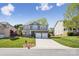 Charming two-story home featuring a stone accent facade, manicured lawn, and a two-car garage at 117 Tom Sawyer Ln, Mount Holly, NC 28120