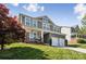 Charming two-story home boasting a covered front porch and well-manicured front lawn at 117 Tom Sawyer Ln, Mount Holly, NC 28120