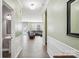 Hallway view leading to living room with dark leather sofas and access to a bathroom at 117 Tom Sawyer Ln, Mount Holly, NC 28120