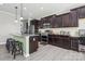 Stylish kitchen featuring dark cabinetry, granite countertops, and stainless steel appliances at 117 Tom Sawyer Ln, Mount Holly, NC 28120