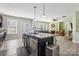 Open kitchen with a central island, breakfast bar, and seamless connection to the living area at 117 Tom Sawyer Ln, Mount Holly, NC 28120