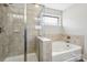 Stylish bathroom featuring a shower with glass door and a separate soaking tub at 117 Tom Sawyer Ln, Mount Holly, NC 28120