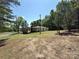 Spacious backyard with lush green grass, surrounded by mature trees at 12719 Cottonville Rd, Norwood, NC 28128