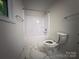 Bathroom showcases modern fixtures, marble-look flooring and shower tub at 12719 Cottonville Rd, Norwood, NC 28128