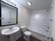 Bathroom features a shower-tub combo with a modern vanity and fixtures at 12719 Cottonville Rd, Norwood, NC 28128