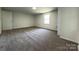 Large carpeted bedroom with neutral walls and trim at 12719 Cottonville Rd, Norwood, NC 28128