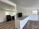 Modern kitchen featuring granite countertops, black appliances, and a breakfast bar for casual dining at 12719 Cottonville Rd, Norwood, NC 28128