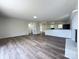 Bright living room showcasing stylish flooring, fresh paint, and an open layout leading to the kitchen at 12719 Cottonville Rd, Norwood, NC 28128