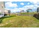 Expansive backyard with a fire pit and a fenced perimeter, perfect for outdoor activities and entertaining at 132 Moores Branch Rd, Mount Holly, NC 28120