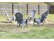 Backyard area with Adirondack chairs surrounding a fire pit, perfect for outdoor entertaining and relaxation at 132 Moores Branch Rd, Mount Holly, NC 28120