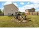 Spacious backyard featuring a fire pit with chairs, ideal for outdoor gatherings and cozy evenings at 132 Moores Branch Rd, Mount Holly, NC 28120