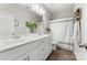 Bright bathroom featuring a double vanity with marble countertop, modern fixtures, and a stylish shower curtain at 132 Moores Branch Rd, Mount Holly, NC 28120