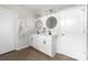 Bright bathroom featuring a double vanity, modern lighting, and wood-look flooring at 132 Moores Branch Rd, Mount Holly, NC 28120
