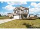 Charming two-story home with a two car garage, a well-manicured lawn, and a cozy front porch at 132 Moores Branch Rd, Mount Holly, NC 28120