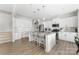 Bright kitchen features granite countertops, stainless steel appliances, white cabinets, a large island, and wood-look flooring at 132 Moores Branch Rd, Mount Holly, NC 28120