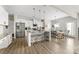 Bright kitchen features stainless appliances, white cabinetry, granite countertops, and island with bar stool seating at 132 Moores Branch Rd, Mount Holly, NC 28120
