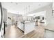 Bright open concept kitchen overlooks dining area and living room with fireplace and plenty of natural light at 132 Moores Branch Rd, Mount Holly, NC 28120