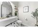 Stylish powder room with modern vanity, decorative mirror, and elegant fixtures at 132 Moores Branch Rd, Mount Holly, NC 28120