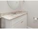 Well-lit bathroom vanity with granite countertop, white cabinets, and a round mirror at 1336 26Th Ne Ave, Hickory, NC 28601