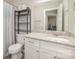 Clean bathroom featuring granite vanity, storage shelves, white cabinets, and a framed mirror at 1336 26Th Ne Ave, Hickory, NC 28601
