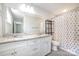 Bright bathroom featuring dual sinks, granite countertop, and a shower with a floral curtain at 1336 26Th Ne Ave, Hickory, NC 28601