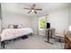 Bedroom with light pink accents, carpet flooring, ceiling fan, and a workspace next to a window at 1336 26Th Ne Ave, Hickory, NC 28601