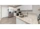 Contemporary kitchen with stainless steel refrigerator, range, and countertops, complete with white cabinets and hardwood floors at 1336 26Th Ne Ave, Hickory, NC 28601