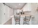 Modern kitchen island with bar stool seating and stainless steel appliances, complemented by stylish countertops and white cabinetry at 1336 26Th Ne Ave, Hickory, NC 28601