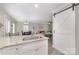 Open kitchen view featuring granite countertops, a barn door, and seamless flow to living spaces at 1336 26Th Ne Ave, Hickory, NC 28601